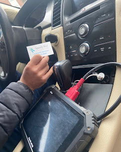 automotive locksmith programming car key inside vehicle